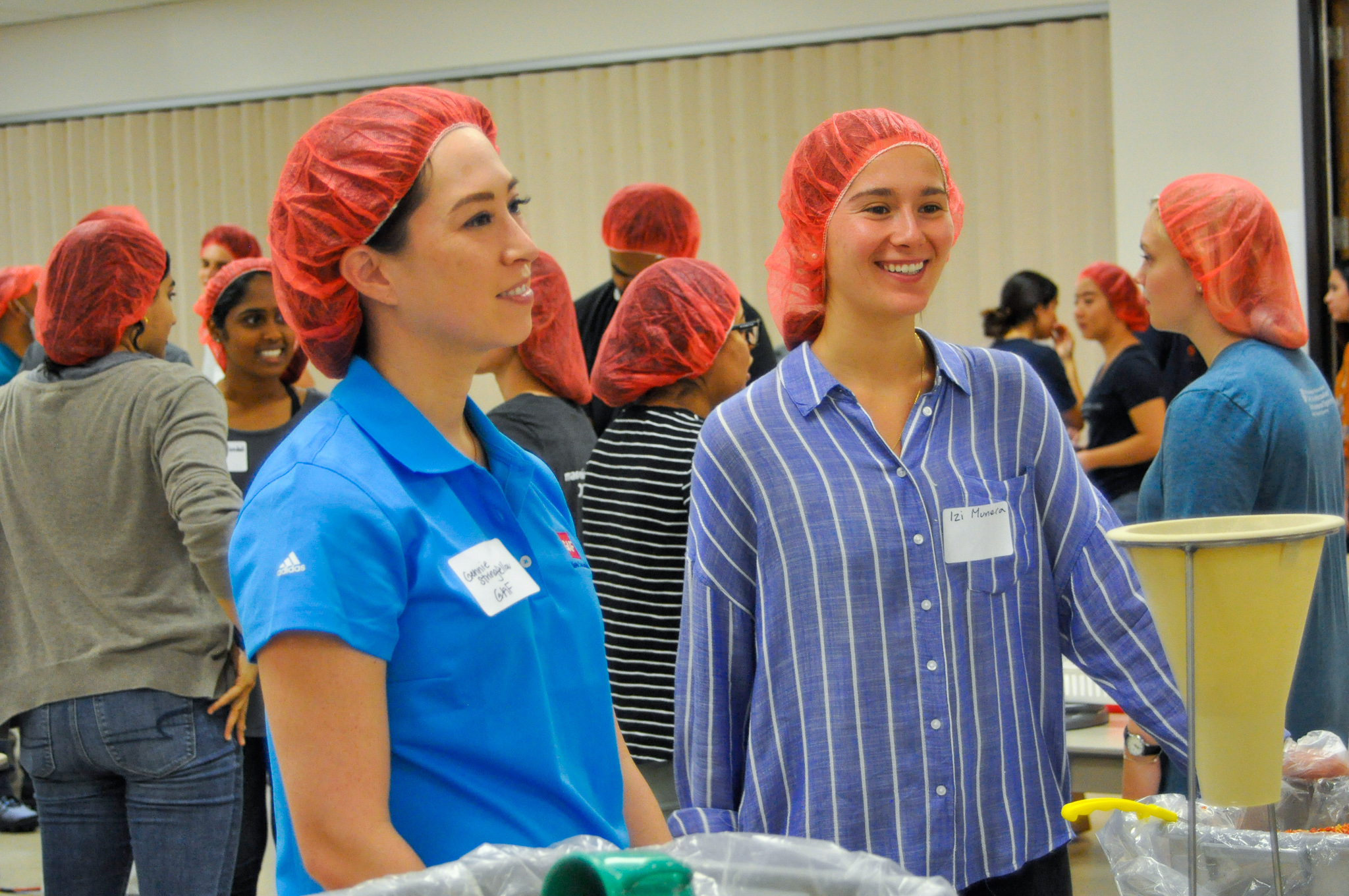 Recruiter and student smiling while volunteering